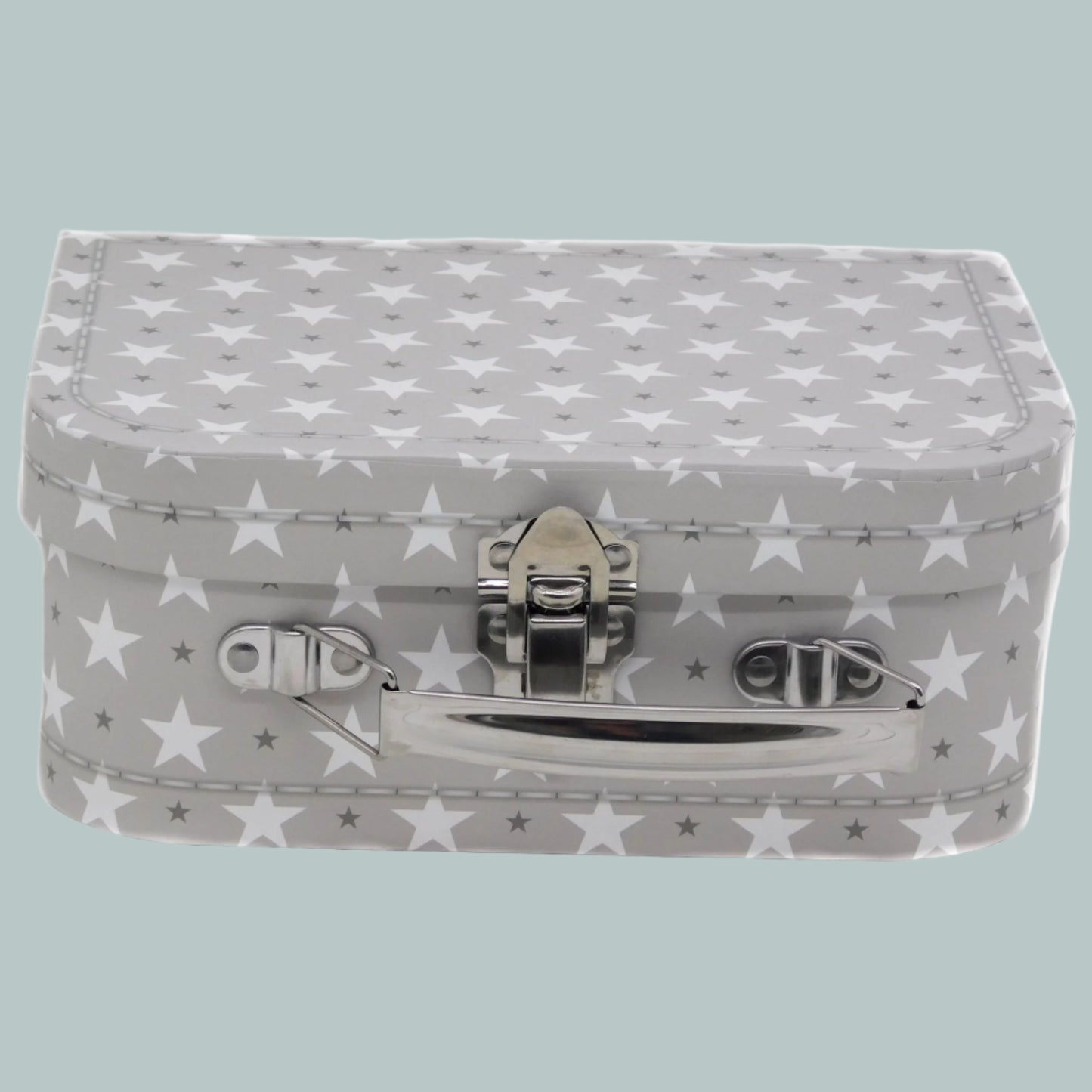 Small grey keepsake suitcase with star pattern on a neutral background