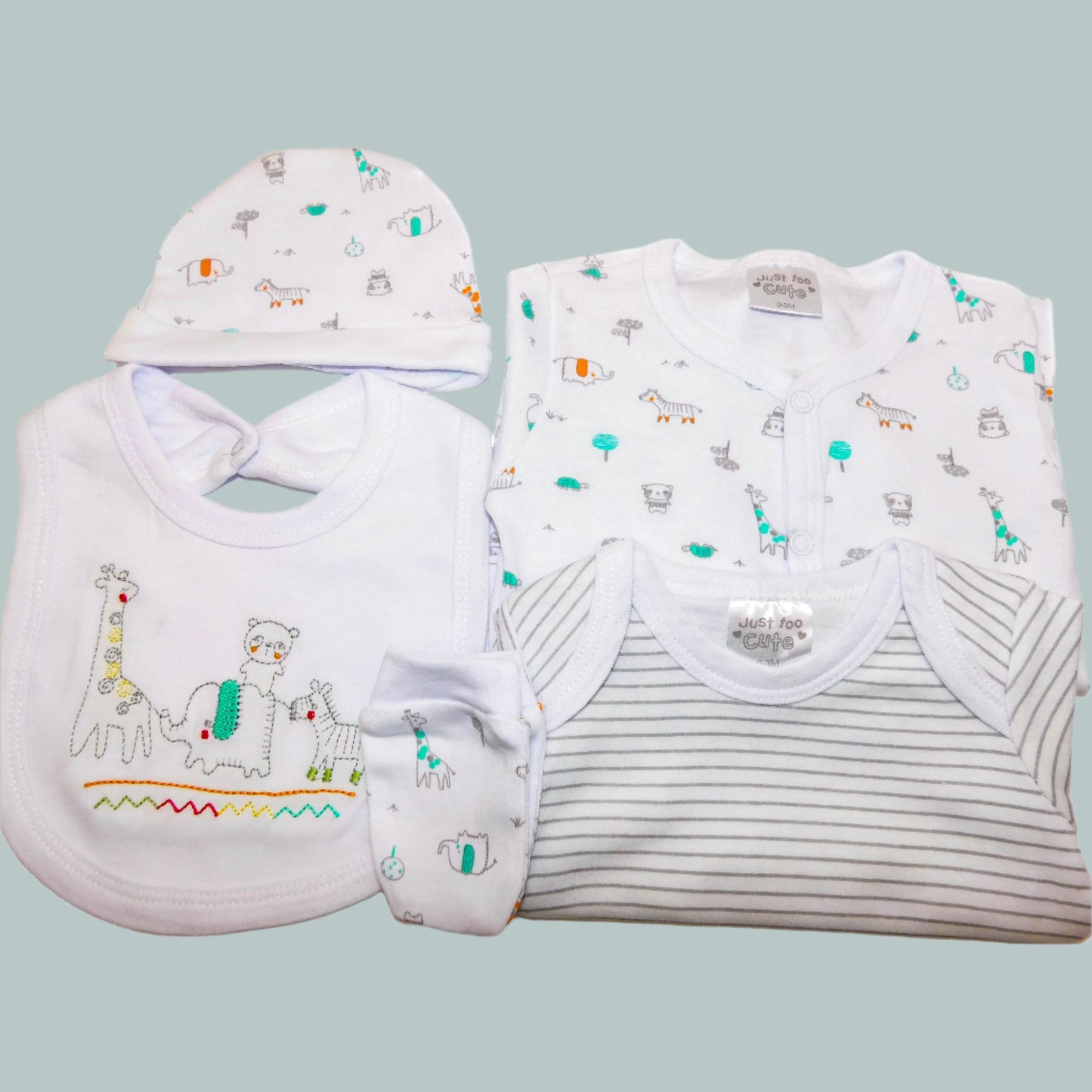 Baby clothing set with hat, bib, sleepsuit, bodysuit and mittens on a neutral background