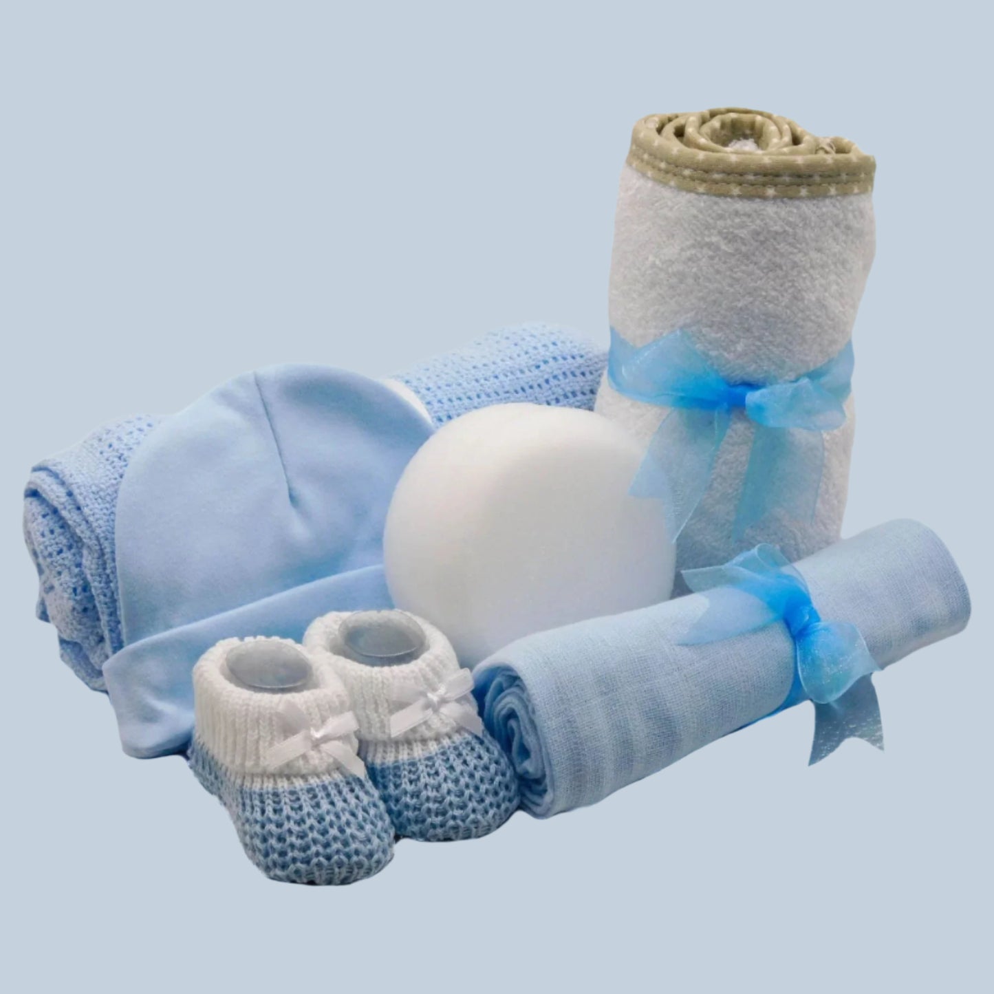 Baby Boy gift set with blue and white items on a pale blue background