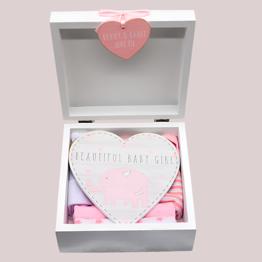 Heart-shaped door plaque with 'Beautiful Baby Girl' text in a gift box on a pink background