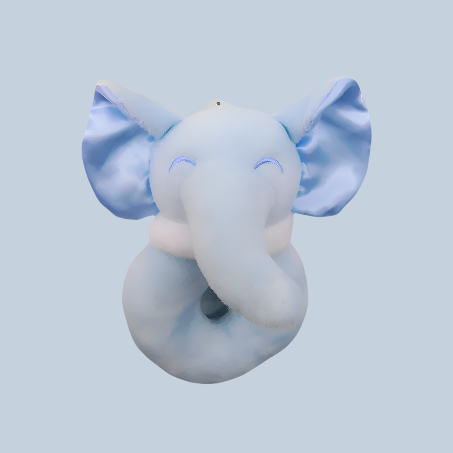 Plush elephant rattle on a light blue background