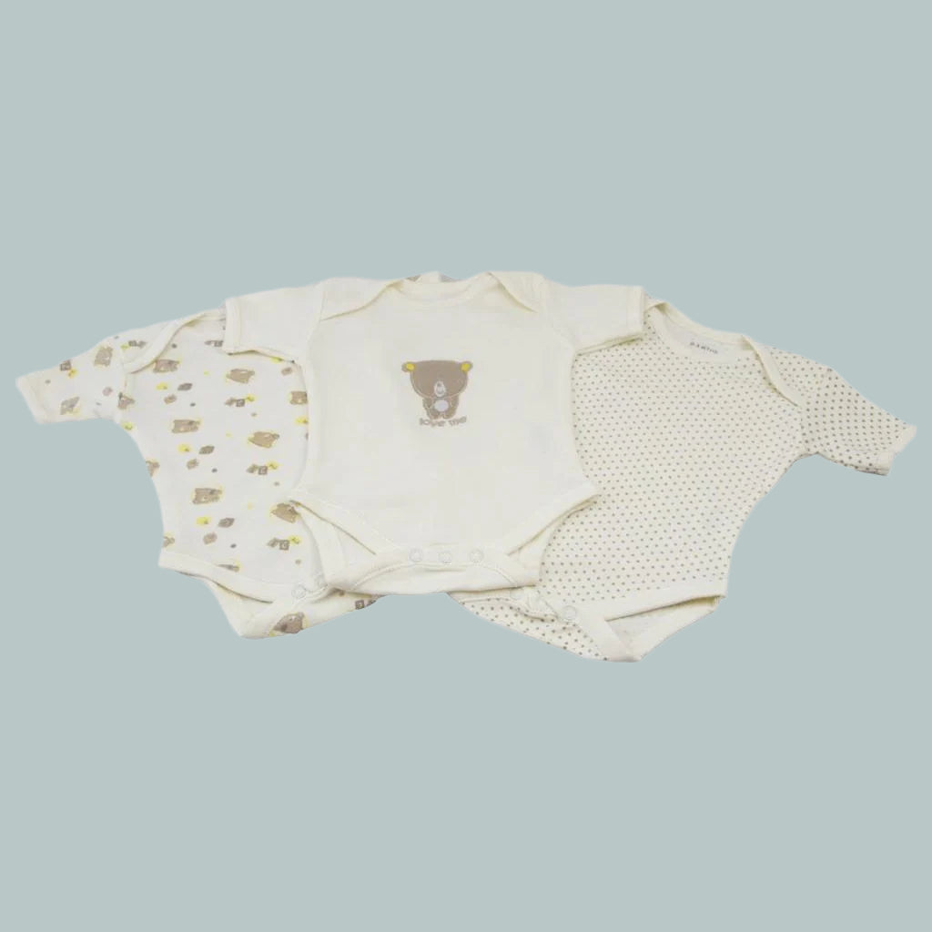 Set of baby clothes with bear designs on a neutral background