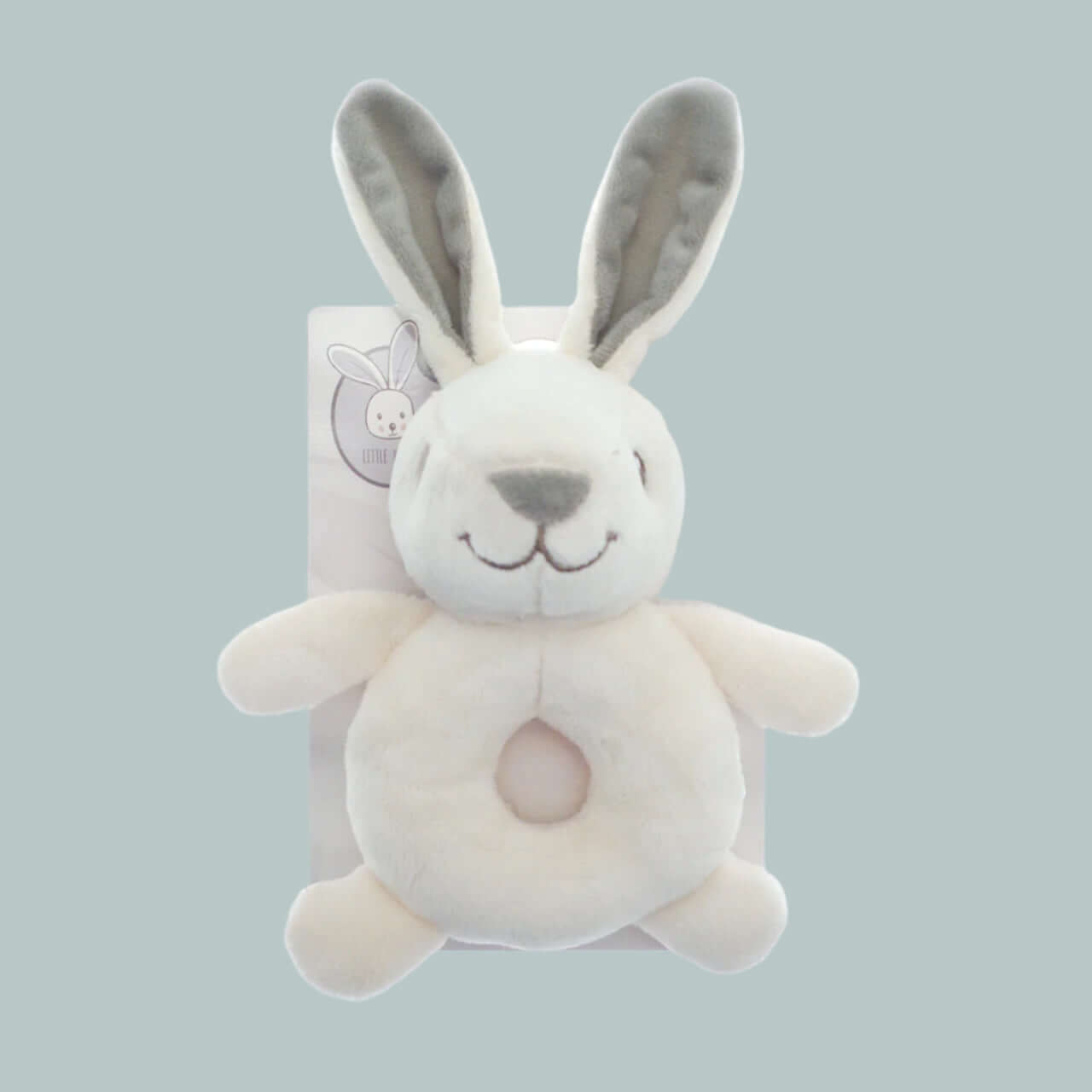 Plush smiling bunny rabbit ring rattle with a neutral background
