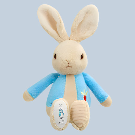 Plush Peter Rabbit bean rattle wearing a blue sweater on a pale blue background