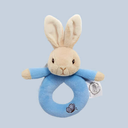 Plush Peter Rabbit ring rattle toy with blue background