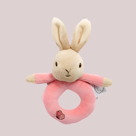Flopsy Bunny plush ring rattle toy on a pale pink background