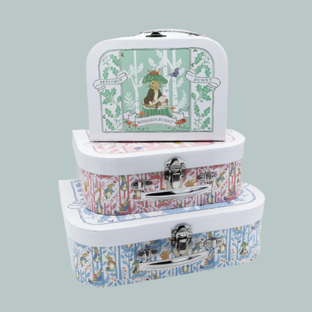 Set of three stacked Peter Rabbit keepsake suitcases on a neutral background