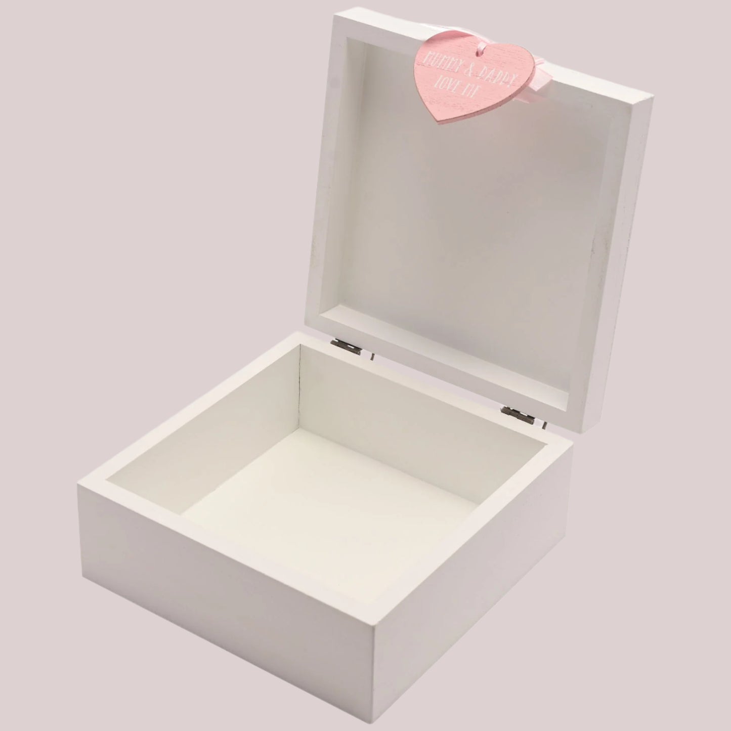 White wooden keepsake box with a pink heart-shaped tag on a pale pink background