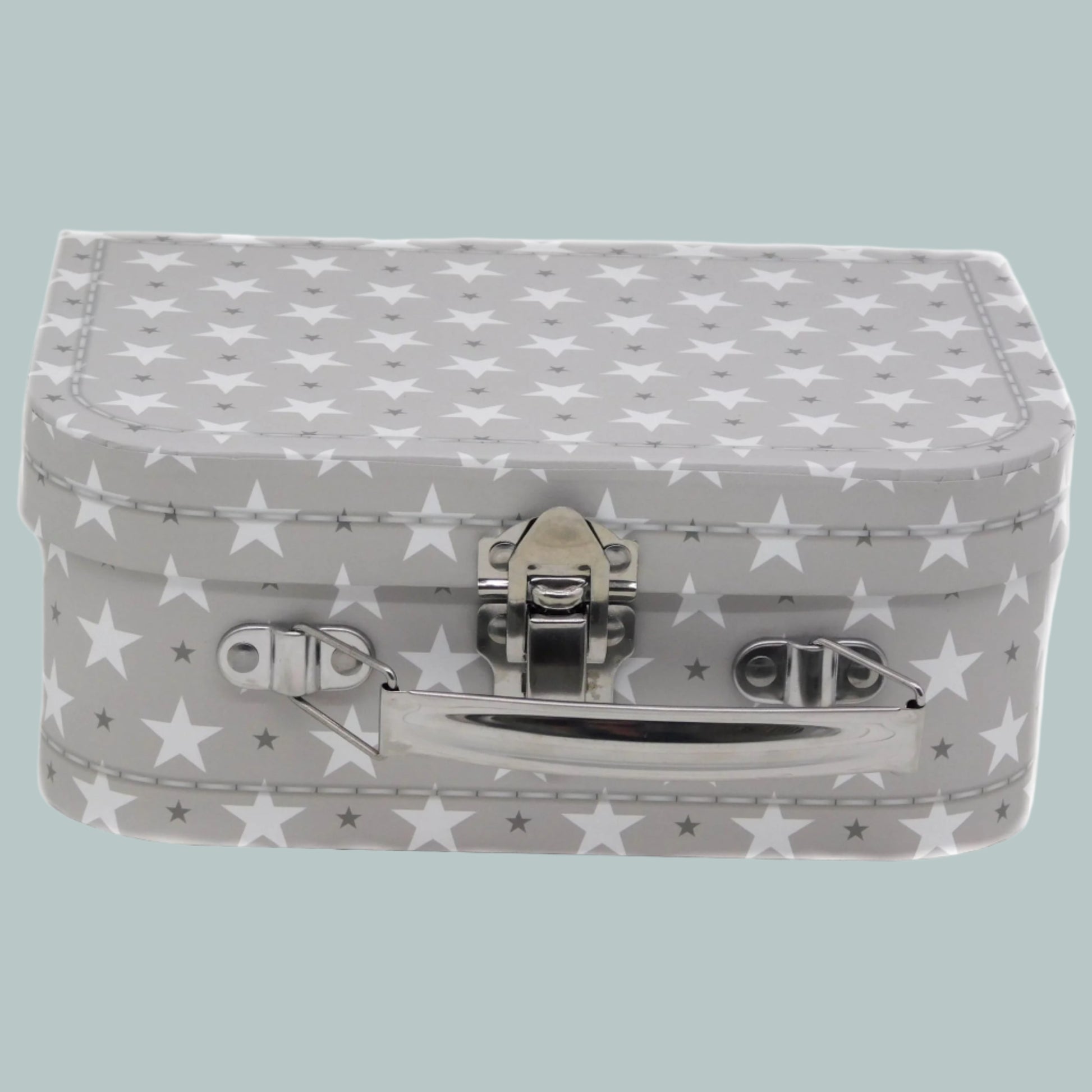 Small grey keepsake suitcase with star pattern on a neutral background