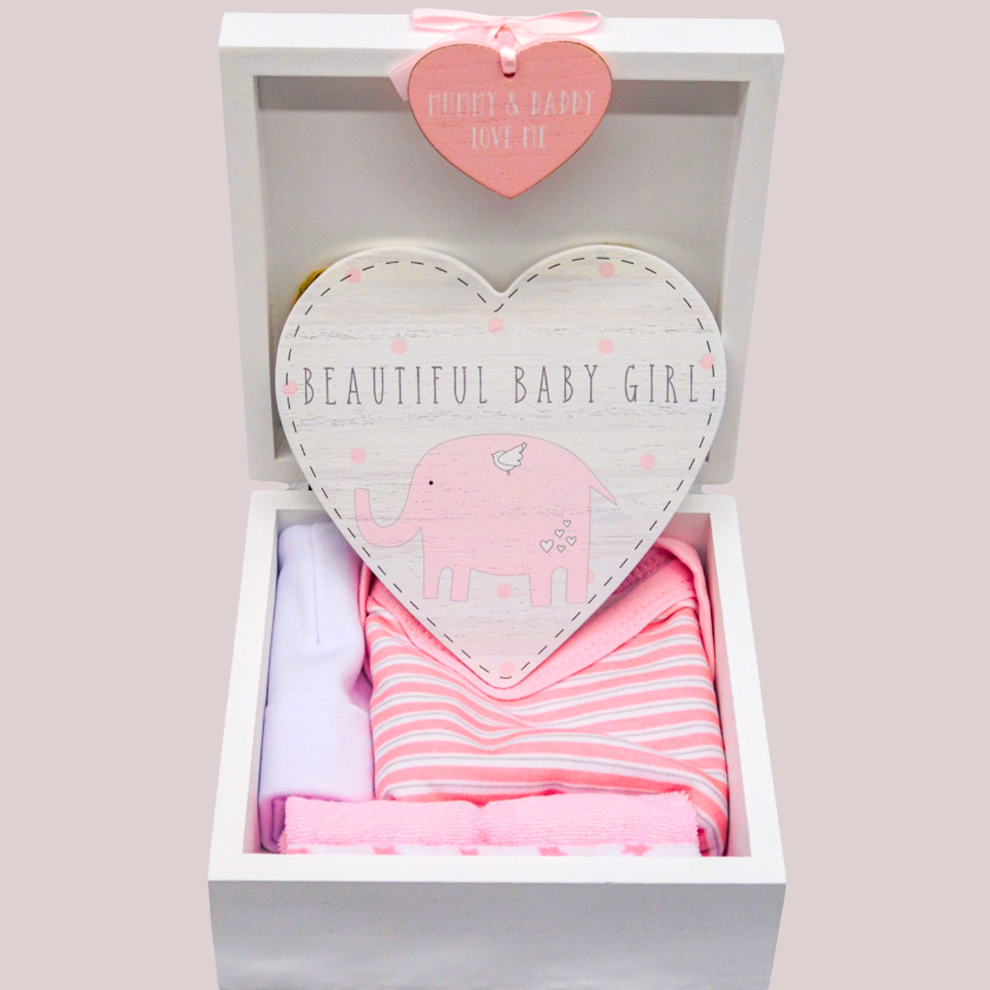 Baby girl gift set with heart-shaped elephant hanging door plaque, pink and white bodysuit, white hat, and washcloths in a keepsake box with a heart-shaped tag.