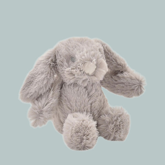 Plush grey toy bunny rabbit on a neutral background