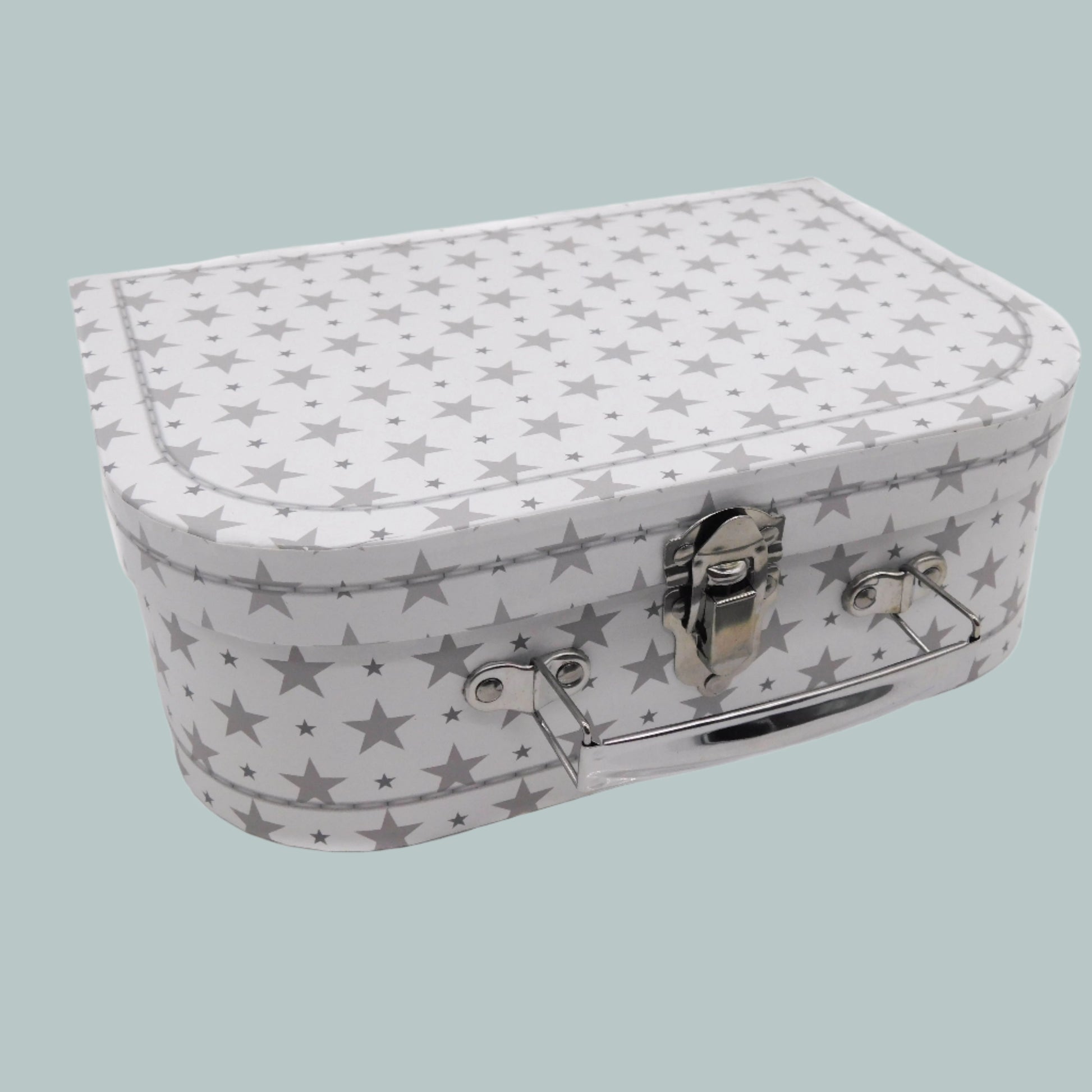 White and grey star-patterned keepsake suitcase on a neutral background