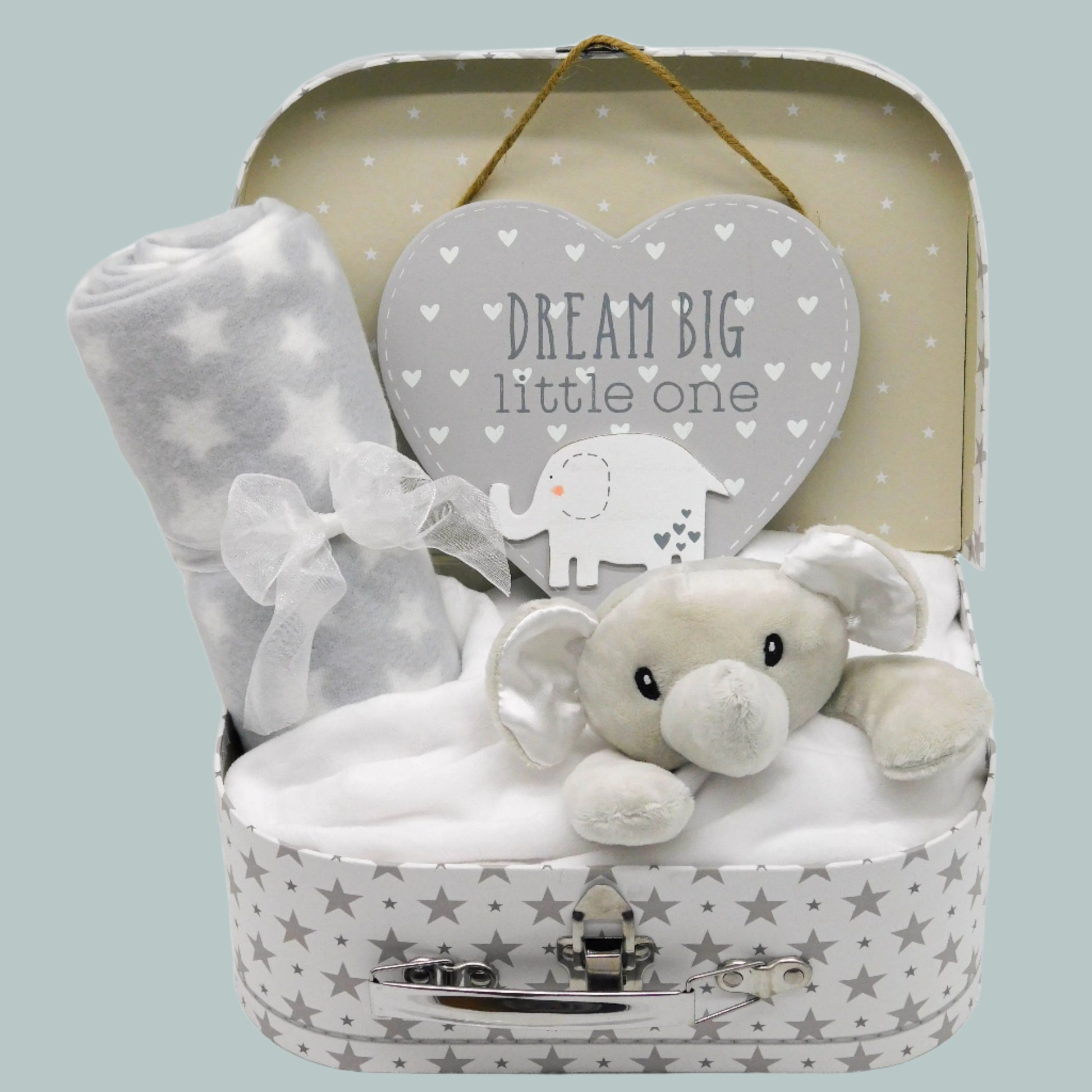 Neutral Baby gift set with plush elephant comforter, fleece blanket, and heart-shaped door-hanging plaque in a star-patterned keepsake suitcase.
