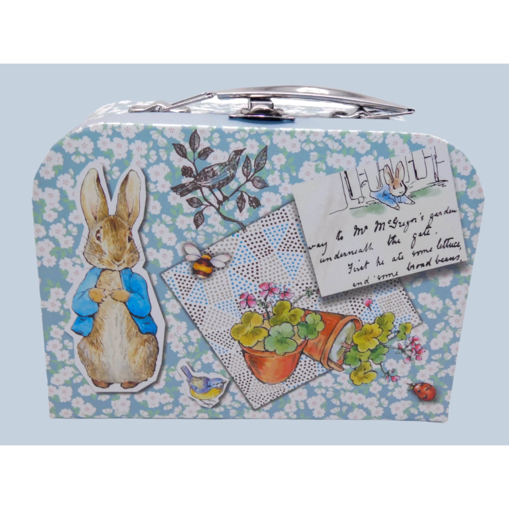 Small Peter Rabbit keepsake suitcase with vintage-style design featuring a Peter Rabbit and floral patterns on a light blue background.