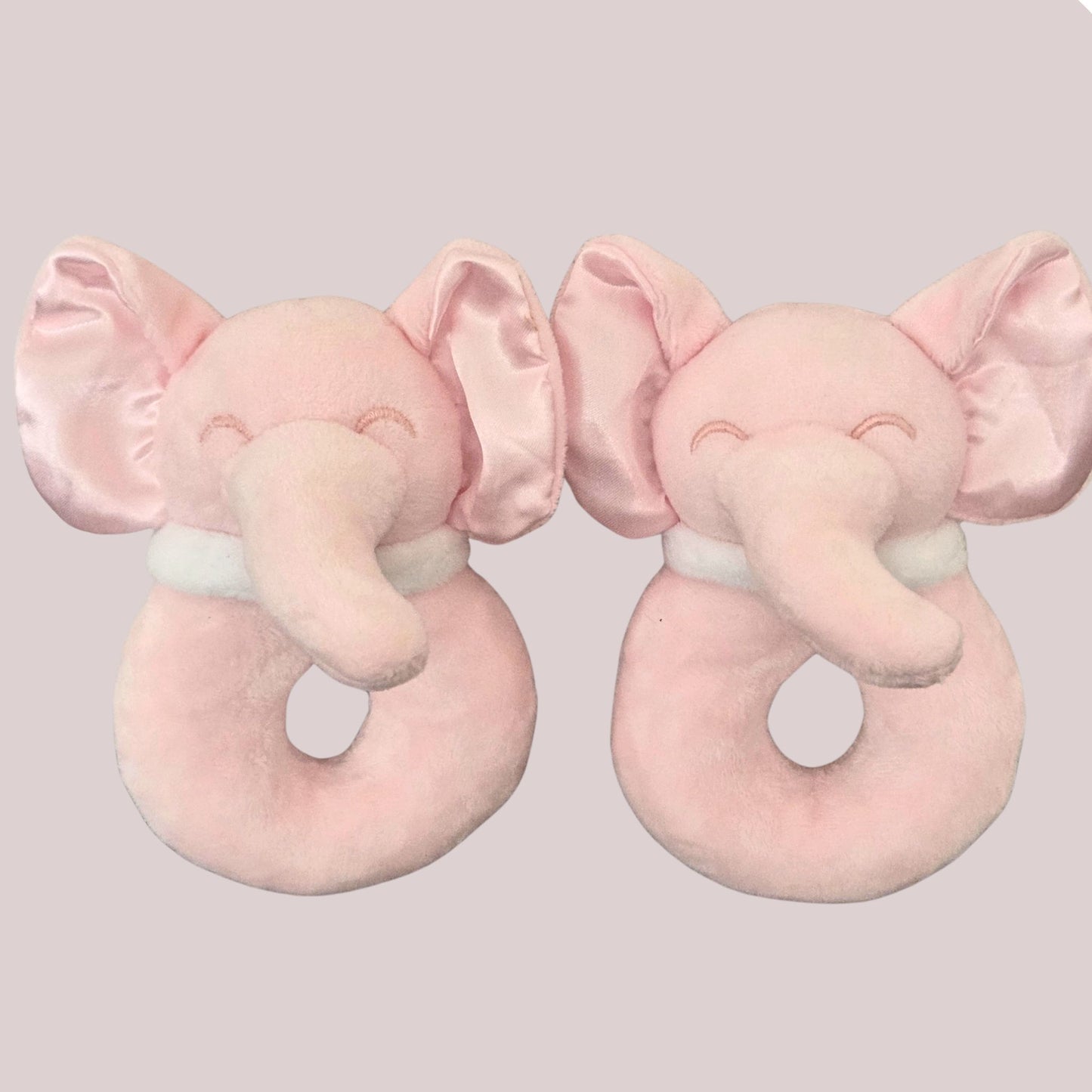 Two soft pink elephant ring rattles side by side