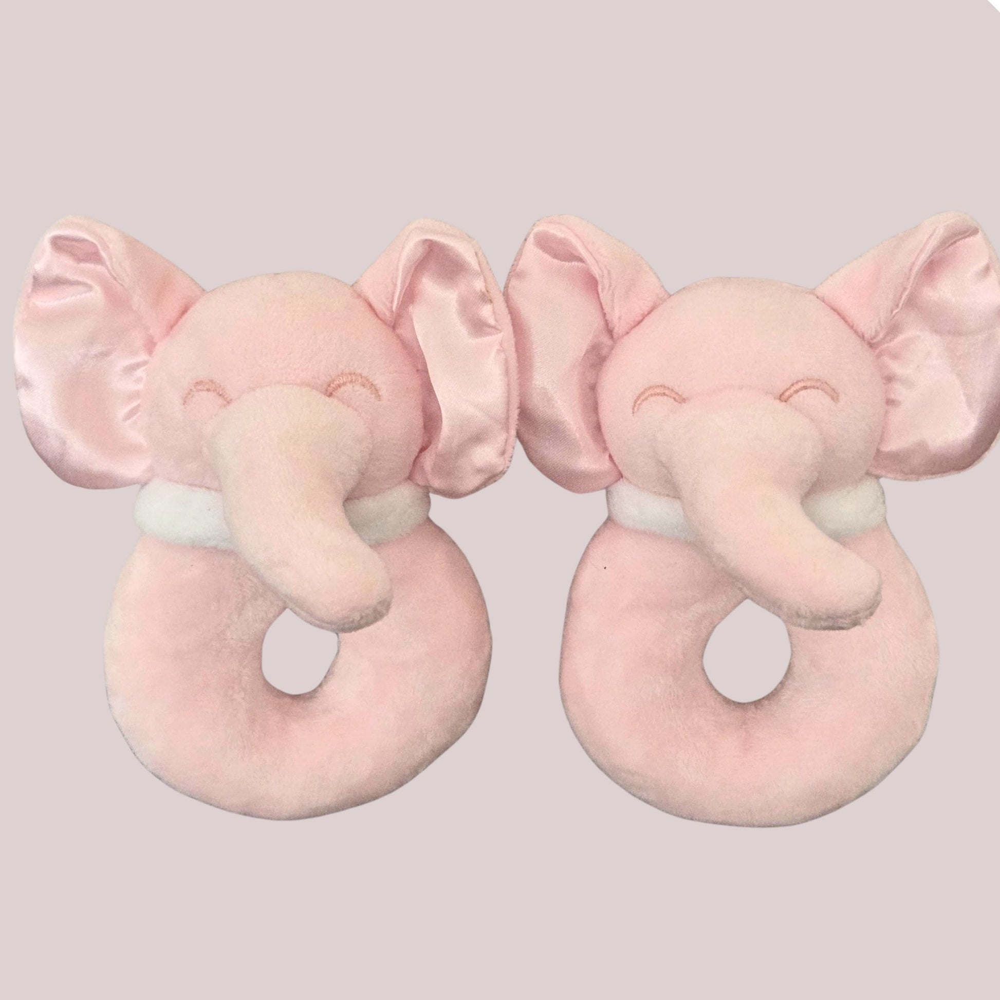 Two soft pink elephant ring rattles side by side