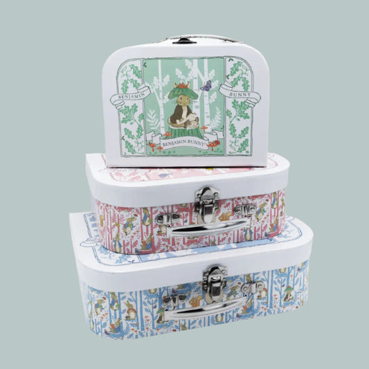 Set of three stacked Peter Rabbit keepsake suitcases on a neutral background
