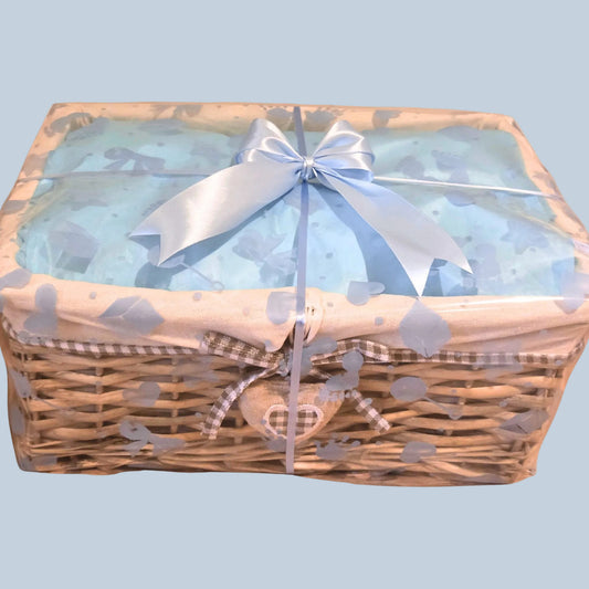 Wicker basket with a plush cottonheart, wrapped in cellophane and finished with a baby blue satin bow

