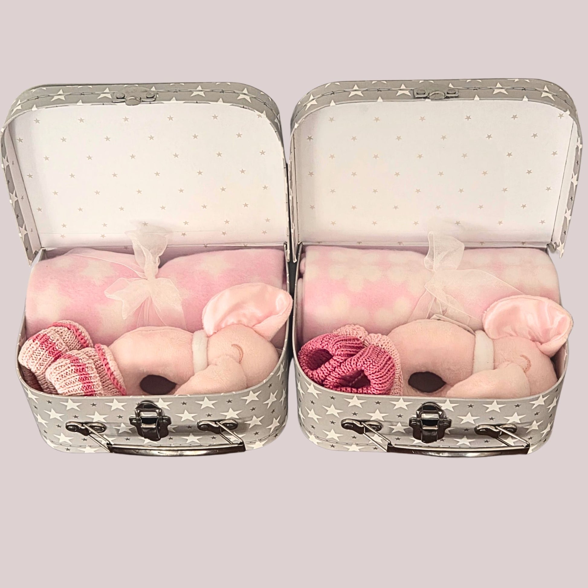 Two twin baby girls keepsake boxes, packed with matching elephant rattles, & complementary blankets & booties