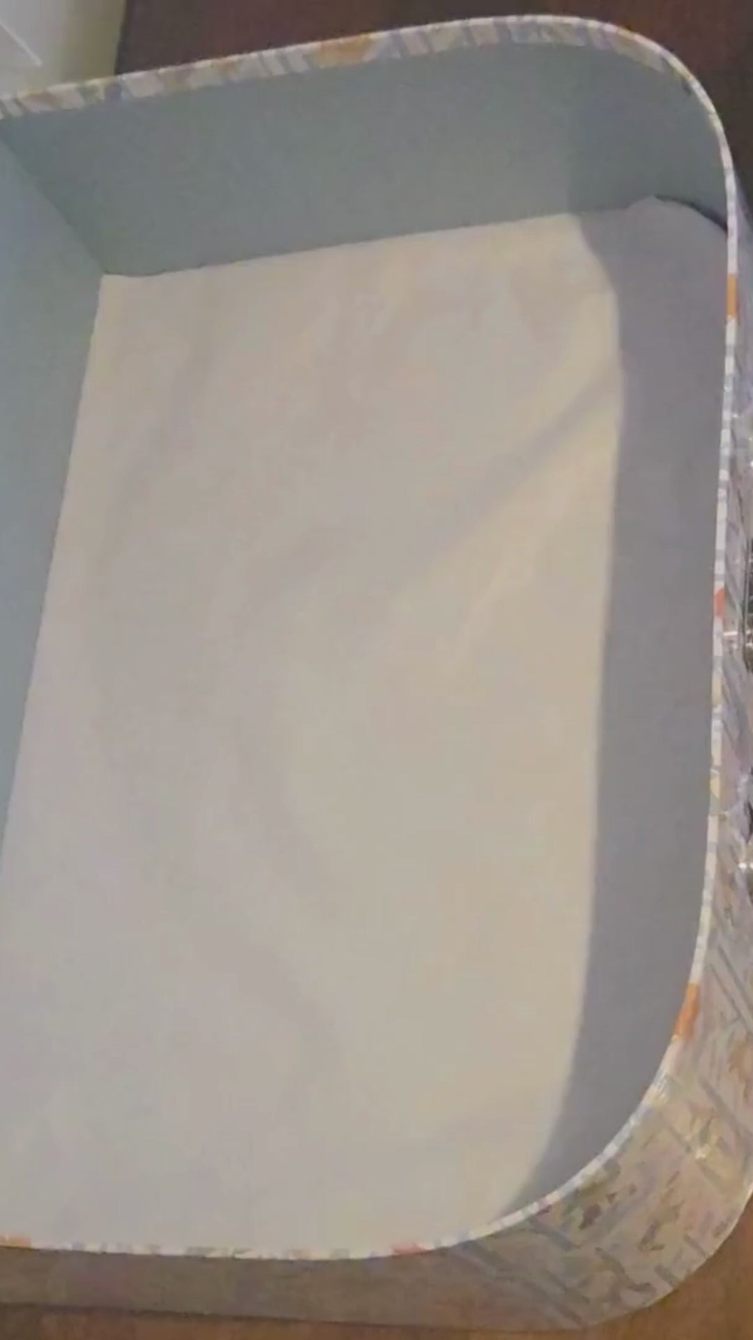 Video of a keepsake box baby gift being packed with cotton clothing, bathtime accesories and a Peter Rabbit rattle